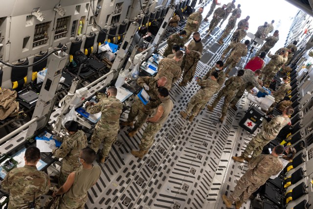A joint team of Medical, Logistical, and Operational Guardsmen based out of Oahu Island administers COVID-19 vaccines to Airmen and Soldiers on Jan. 5, 2021, at Kahului, Hawaii. A C-17 Globemaster III, operated by 154th Wing Airmen, was modified into a mobile vaccination clinic to administer the COVID-19 vaccine to Airmen and Soldiers on neighboring islands. (U.S. Air National Guard photo by Senior Airman John Linzmeier)