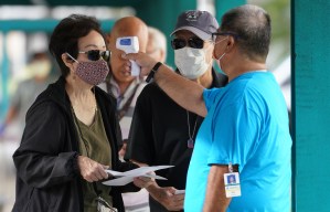 Staff assist with checking seniors’ temperature upon arrival at the Blaisdell Concert Hall during COVID-19 vaccinations. January 25, 2021