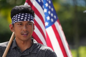 Trump supporter Edward Dirige from Waipahu stands with about a couple dozen demonstrators fronting the Capitol. January 6, 2021
