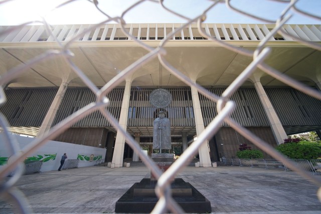 Father Damien statue as seen thru the newly installed fenced barrier at the Capitol. January 13, 2021.