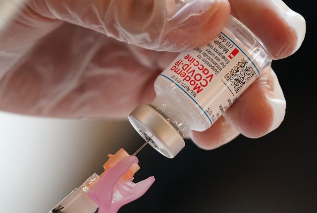 Pharmacist Davis Zheng fills syringe with the Moderna COVID-19 vaccine. January 5, 2021