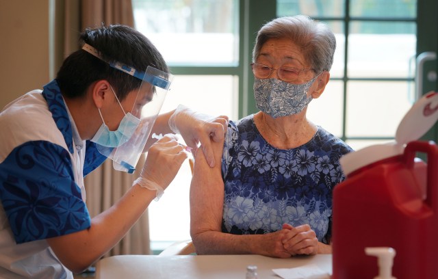 Pharmacist Davis Zheng gives Yasuko Nakamoto the Moderna COVID-19 vaccine at Craigside Place. January 5, 2021.