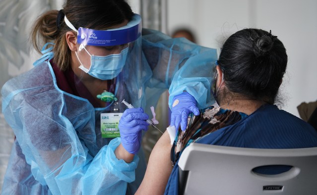 Registered Nurse Alexis Lagasca from Kalihi Palama Health Center gives COVID-19 vaccinations at St. Elizabeth Church.