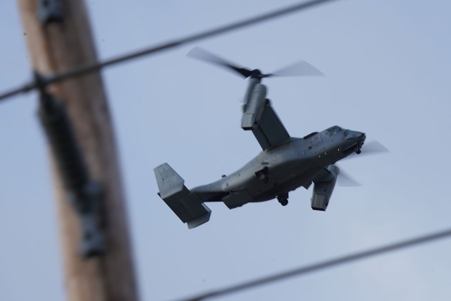 Low flying Bell Boeing V22 Osprey military aircraft travels over Beretania Street.
