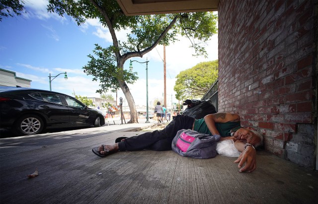 Person sleeps at the entrance to the parking at Chinatown’s Smith Beretania Parking structure.