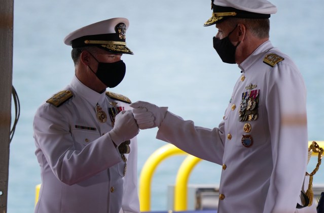 US Indo-Pacific Command change of command ceremony as right, Admiral Philip Davidson gives knuckles to the incoming commander Admiral John Aquilino.