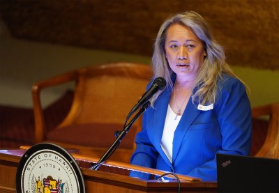 Representative Lynn DeCoite gives the invocation before the House floor session.
