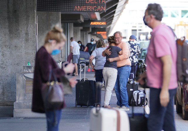 Passengers say goodbye to loved ones on the departure level at the Daniel K. Inouye International Airport during the COVID-19 pandemic. April 1, 2021