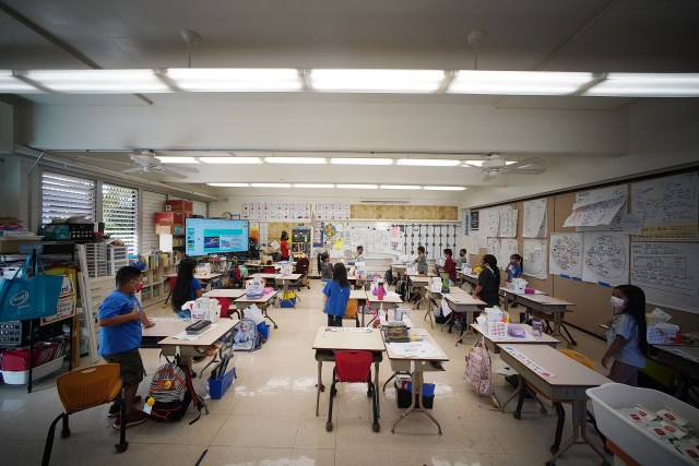 Honowai Elementary School Kindergarten Teacher May Anne Kim in her classroom as students recite the ‘Pledge of Allegiance’.