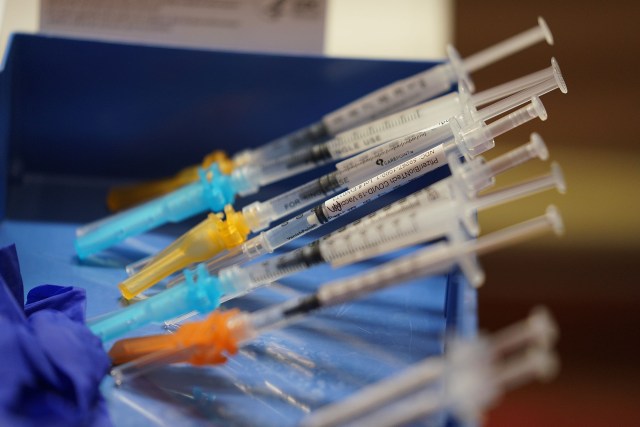 Pfizer COVID-19 vacciine in syringes at Blaisdell Concert Hall.