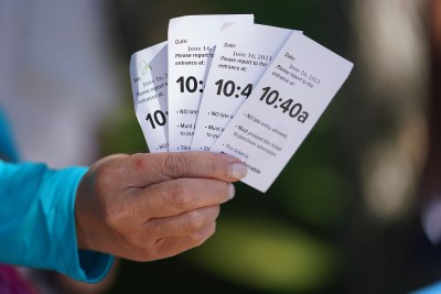Hanauma Bay visitors hold their tickets with the entrance times.