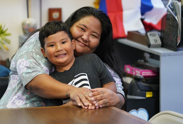 Jennifer Nakamura embraces her son Hisao (she declined on last name) at 46-005 Kawa Street in Kaneohe.