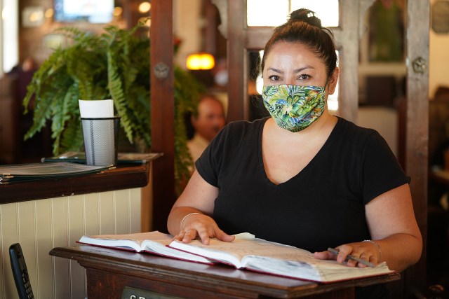 Murphy’s Bar and Grill staff member Cymri Chang at the front of the entrance to the restaurant.