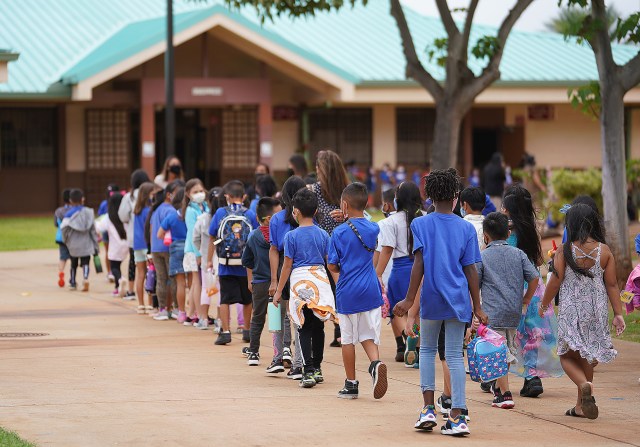 Holomua Elementary School students line up after recess.