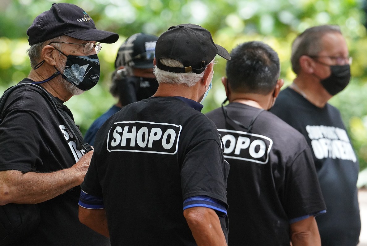 HPD supporters wearing SHOPO shirts stand outside District Court during a preliminary trial in Judge Domingo’s courtroom.