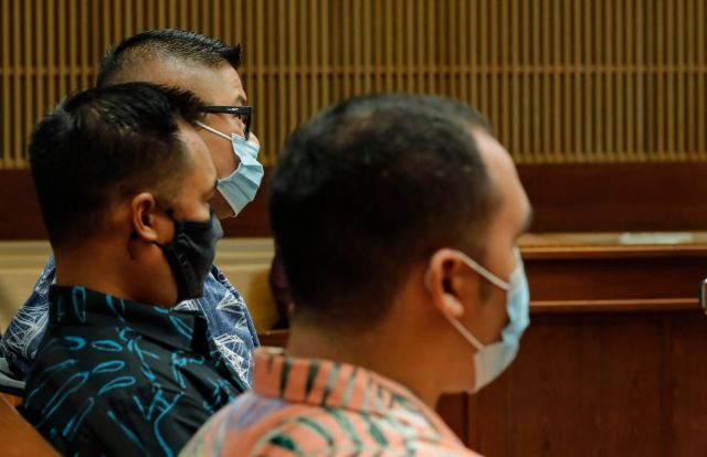 Honolulu police officers Geoffrey Thom, top, Christopher Fredaluces, and Zackary Ah Nee sit in the district courtroom of judge William M. Domingo during the second day of preliminary hearings for three Honolulu police officers in the killing of Iremamber Sykap on Tuesday, July 27, 2021, in Honolulu. (POOL PHOTO/Jamm Aquino/Honolulu Star-Advertiser).