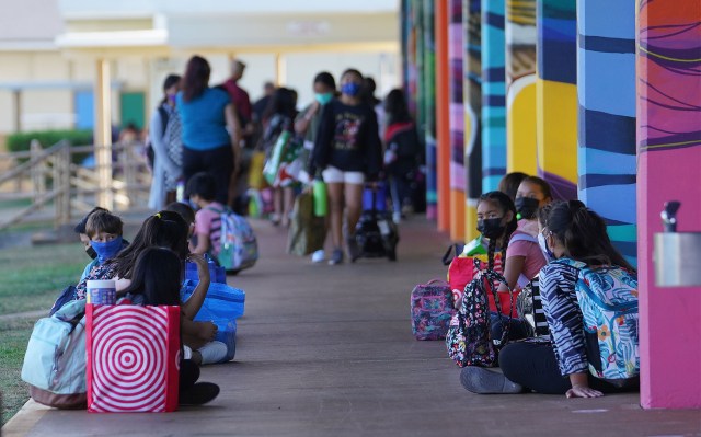 Aliiolani Elementary School students wait outside the classrooms before the start of the first day of school.