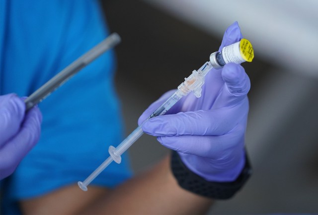Medical staff prepare a Pfizer BioNTech Covid-19 vaccine booster at the Windward YMCA. August 24, 2021