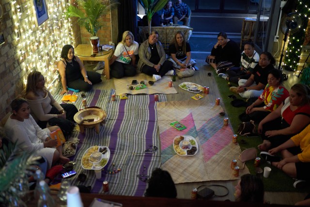 Women sit around the kava bowl, At Four Shells Kava Lounge in Auckland, New Zealand