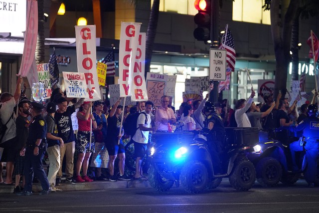 Aloha Freedom Coalition supporters march along Kalakaua Avenue on saturday.