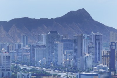 Ala Wai Canal seen on the bottom of the frame with Diamond Head as a backdrop to the Waikiki skyline.