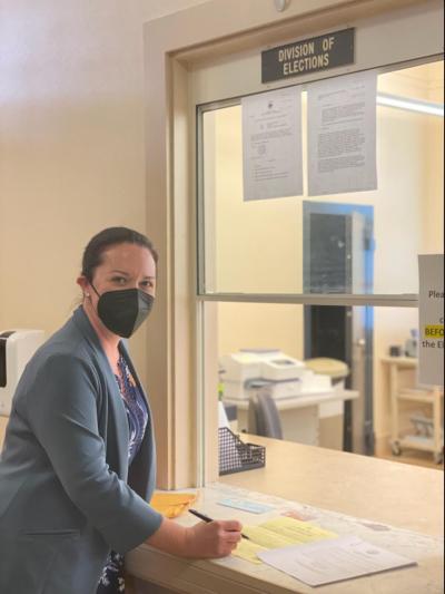 Woman files paperwork at county division of elections office
