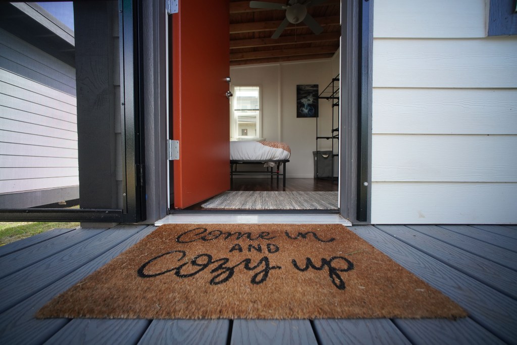 HomeAid Hawaii Opens Doors at Kama’okū.  Entrance with welcome mat at one of the small homes located at Kama’okū.