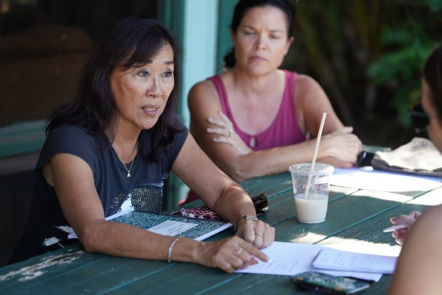 North Shore rental owner SharLyn Foo w right, her neighbor Jill Paulin speak to reporter outisde their residence.