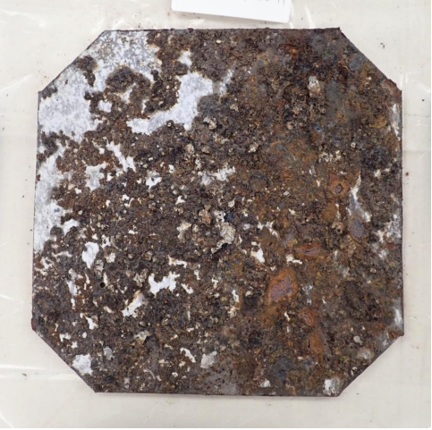 A "coupon," or sample" taken from one of the Red Hill fuel facility tanks shows the level of corrosion the steel has undergone.