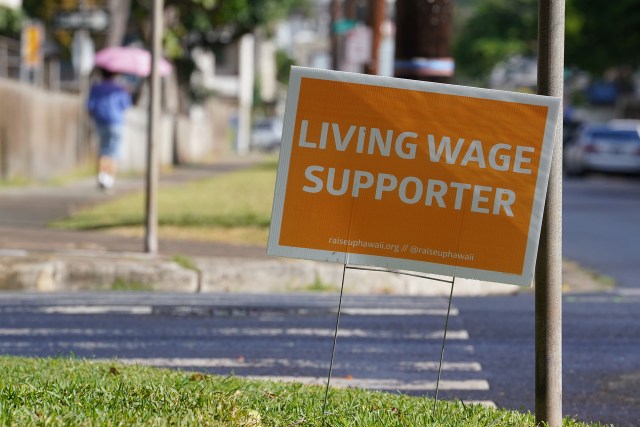 'Living Wage Supporter' sign located at the intersection of Pumehana Street and Fern St.