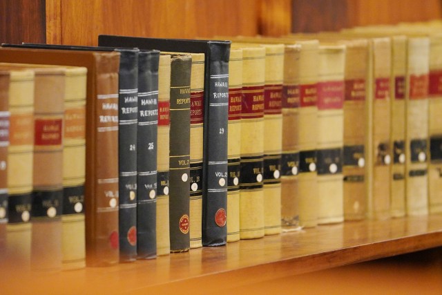 Hawaii State Supreme Court hears oral arguments on a reapportionment case. Volumes of 'Hawaii Reports' located behind the Chief Justice.