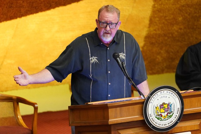 RepresentativeBob McDermott gives a short prayer before floor session begins at the Capitiol.