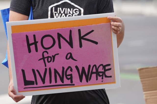 Demonstration held in support of raising the minimum wage in Hawaii at the intersection of Ward Avenue and Kapiolani Boulevard.