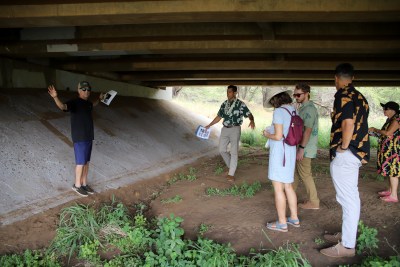 A photo of Kihei Community Association members speaking with U.S. Rep. Kai Kahele about a proposal to build a paved path underneath Piilani Highway.
