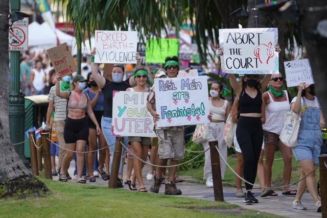 Demonstrators head up Kalakaua Avenue in a rally and march to defend the right to abortion.