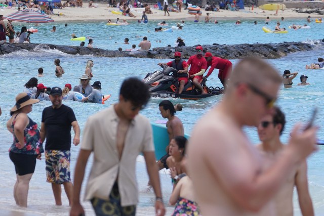 City and County Ocean Safety lifeguards assist on a jet ski offshore Waikiki Beach.