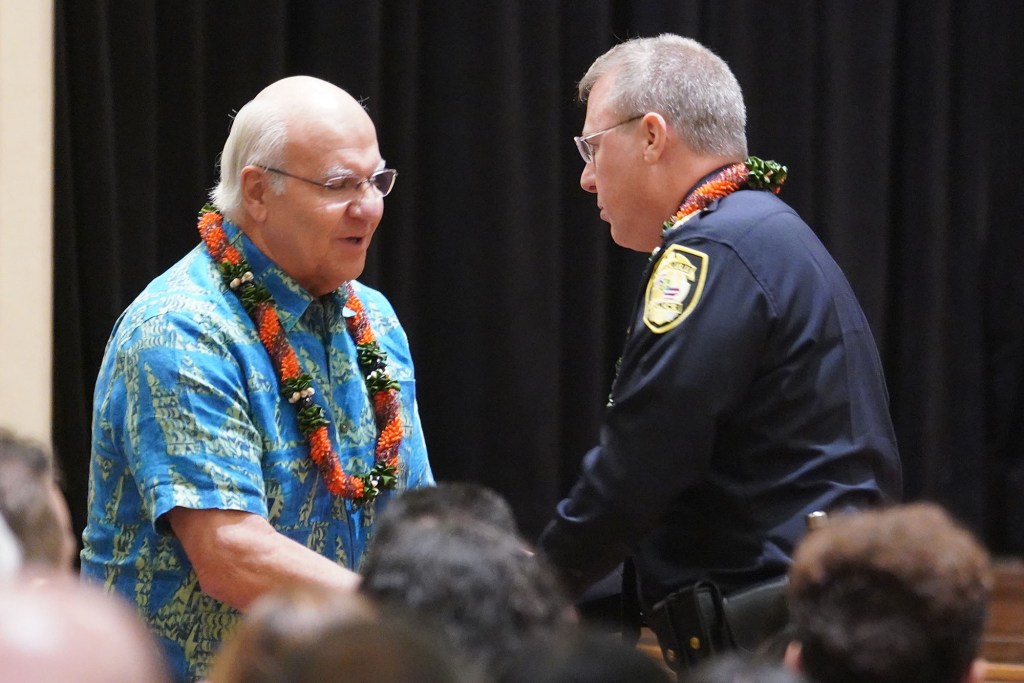 HPD Honolulu Police Chief Joe Logan is greeted by Mayor Rick Blangiardi after being sworn in at the Mission Memorial Auditorium.