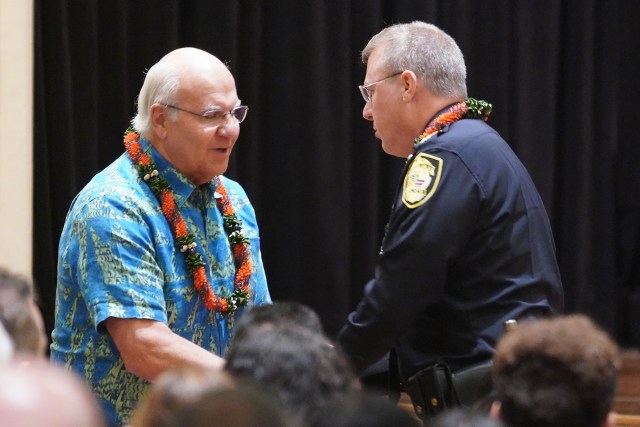 HPD Honolulu Police Chief Arthur Logan is greeted by Mayor Rick Blangiardi after being sworn in at the Mission Memorial Auditorium.
