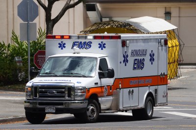 EMS Emergency Medical Services ambulance leaves Queens Hospital.
