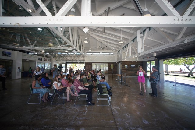 KUPU Net Shed press conference with a small crowd on hand.