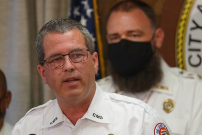 Honolulu EMS Director Jim Ireland speaks with Mayor Blangiardi at a press conference held at Honolulu Hale on the ambulance that caught fire. Ireland said that the Honolulu Fire Department was taking the lead on the fire investigation.