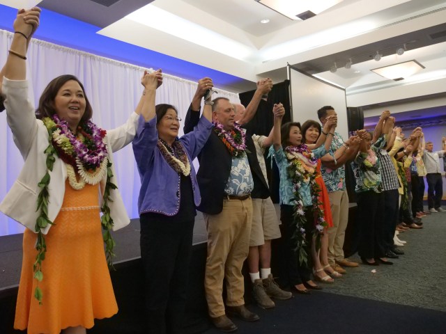 Democratic candidates raising hands together during the Democratic Party of Hawaii Unity Breakfast. Civil Beat photos Ronen Zilberman.