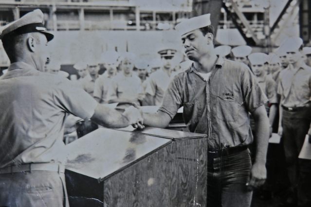 In this undated photo Roberto Garza of Hilo receives an award from his commanding officer as his shipmates look on. Photo: Garza Family
