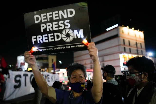 Activists hold slogans as they condemn the killing of Filipino journalist Percival Mabasa during a rally in Quezon city, Philippines on Tuesday Oct. 4, 2022. Motorcycle-riding gunmen killed a longtime radio commentator in metropolitan Manila in the latest attack on a member of the media in the Philippines, considered one of the world's most dangerous countries for journalists. (AP Photo/Aaron Favila)