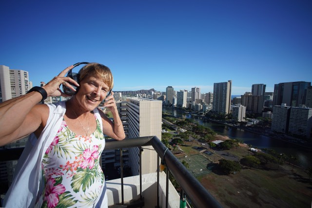 Karin Lynn uses ear protection to keep the rooster's early morning crowing sounds so she can sleep. The crowing sound carries up to her 27th floor unit.