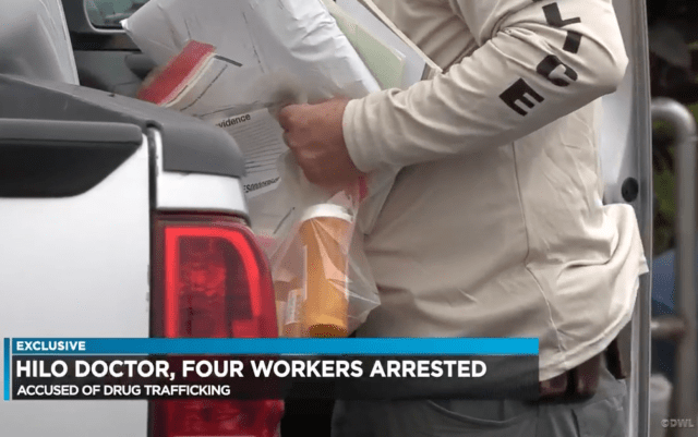 Police remove evidence from a Hilo medical practice illegally disseminating prescription drugs