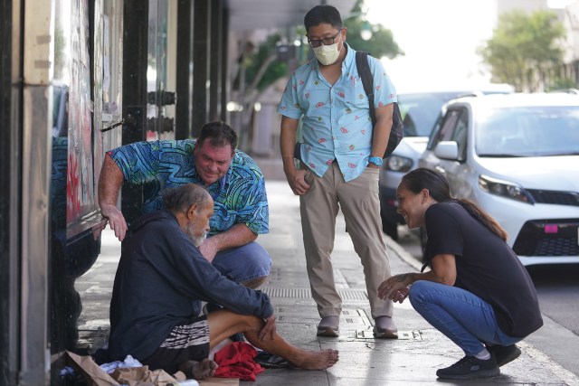 IHS Outreach Navigation Program Coordinator David Warman, Dr. Chad Koyanagi and right, IHS Assistant Outreach Navigation Program Coordinator Shona Cobb stop to assist a man that said he felt sick and needed help.