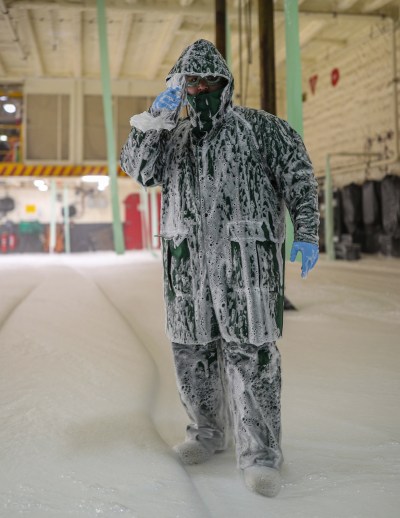 Damage Controlman 3rd Class Francisco Ariz, from San Diego, assigned to USS Gerald R. Ford's (CVN 78) engineering department, stands watch as the aqueous film forming foam (AFFF) push button operator during an AFFF sprinkler test in the hangar bay, Feb. 27, 2022. Ford is underway in the Atlantic Ocean after completing the industrial portion of a six-month Planned Incremental Availability (PIA). (U.S. Navy photo by Mass Communication Specialist 3rd Class Riley McDowell)