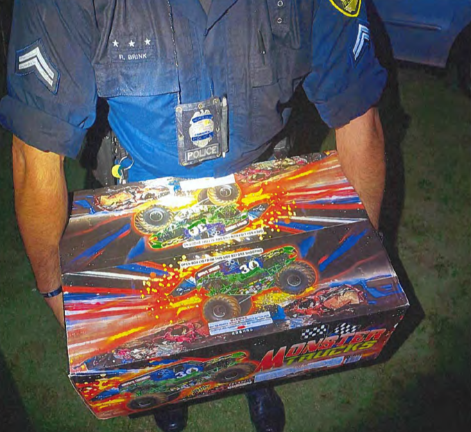 An officer holds a box of fireworks confiscated from a U-Haul in Kailua.