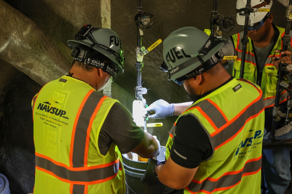 Fuel operators with Joint Task Force-Red Hill (JTF-RH) collect a fuel sample during dewatering at the Red Hill Bulk Fuel Storage Facility in Halawa, Hawaii, April 18, 2023. Dewatering removes the water from the fuel storage tanks. This is a routine task for maintenance of underground fuel storage tanks and is essential to prevent corrosion and protect fuel quality. Regulators from the Hawaii Department of Health and the Environmental Protection Agency are on site during dewatering. JTF-RH is committed to working with regulators, government officials, and stakeholders to ensure Red Hill is defueled safely, expeditiously and in compliance with all applicable laws and regulations.